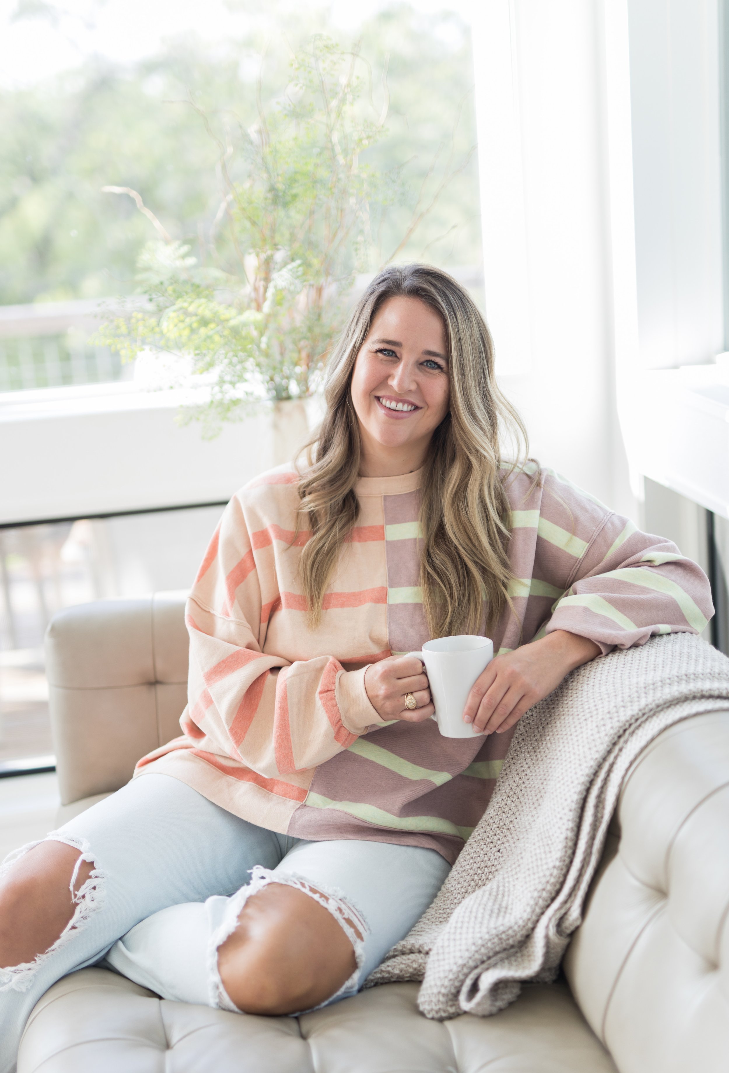 Rachel Bass, owner of Balanced Bookkeeping Co., smiling at home